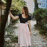 Premium Versatile Collection Dirndl Shannon rental: navy bodice, pink apron, elegant 70 cm skirt—for Oktoberfest in Munich.