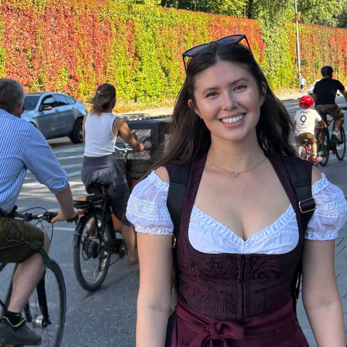 Versatile Collection Dirndl Kim rented for Oktoberfest via Versatile OTM. Woman wearing red Versatile OTM Dirndl with a Dirndl Blouse ready to rent on Versatile