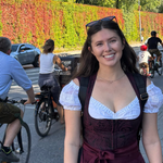 Versatile Collection Dirndl Kim rented for Oktoberfest via Versatile OTM. Woman wearing red Versatile OTM Dirndl with a Dirndl Blouse ready to rent on Versatile