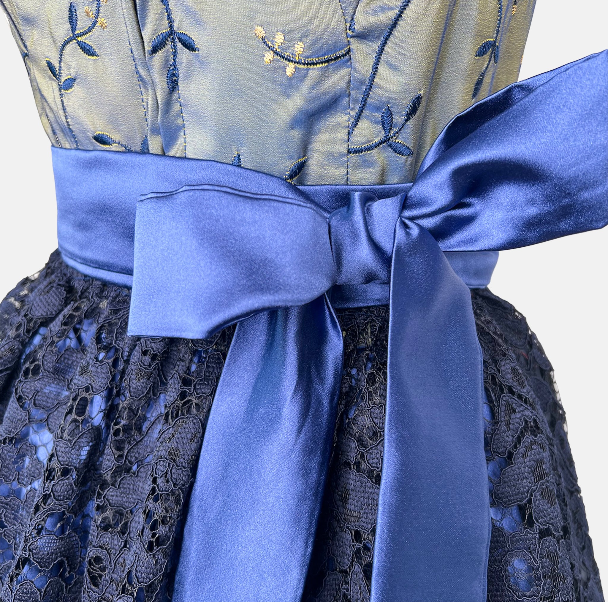 A royal blue traditional dirndl dress with a patterned bodice, lace skirt, and a silky blue ribbon. Rent your Dirndl for Oktoberfest as stunning as this Dirndl