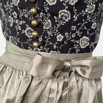 Elegant traditional Wenger Dirndl with floral embroidery and satin apron – available to rent via Versatile for Oktoberfest or festive events.