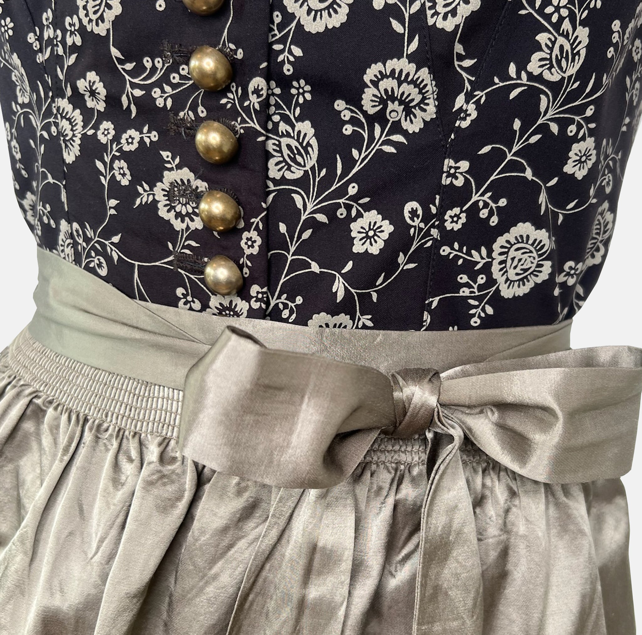 Elegant traditional Wenger Dirndl with floral embroidery and satin apron – available to rent via Versatile for Oktoberfest or festive events.
