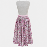 Back view of Almsach Dirndl with plain grey beige bodice, pink waist sash and multicoloured floral skirt