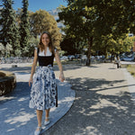 Alpenherz Marina dirndl in navy jacquard with embroidered tulle apron—versatile rental dress for Oktoberfest in Munich.