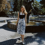Munich dirndl rental: Alpenherz Marina with dark blue jacquard bodice and delicate embroidered tulle apron—ideal for Oktoberfest.