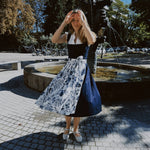 Munich dirndl rental: Alpenherz Marina with dark blue jacquard bodice and delicate embroidered tulle apron—ideal for Oktoberfest.