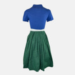 Apple of My Eye dirndl rental via Versatile – deep blue bodice with dotted pattern, white apron with floral stripes, ideal Oktoberfest dress