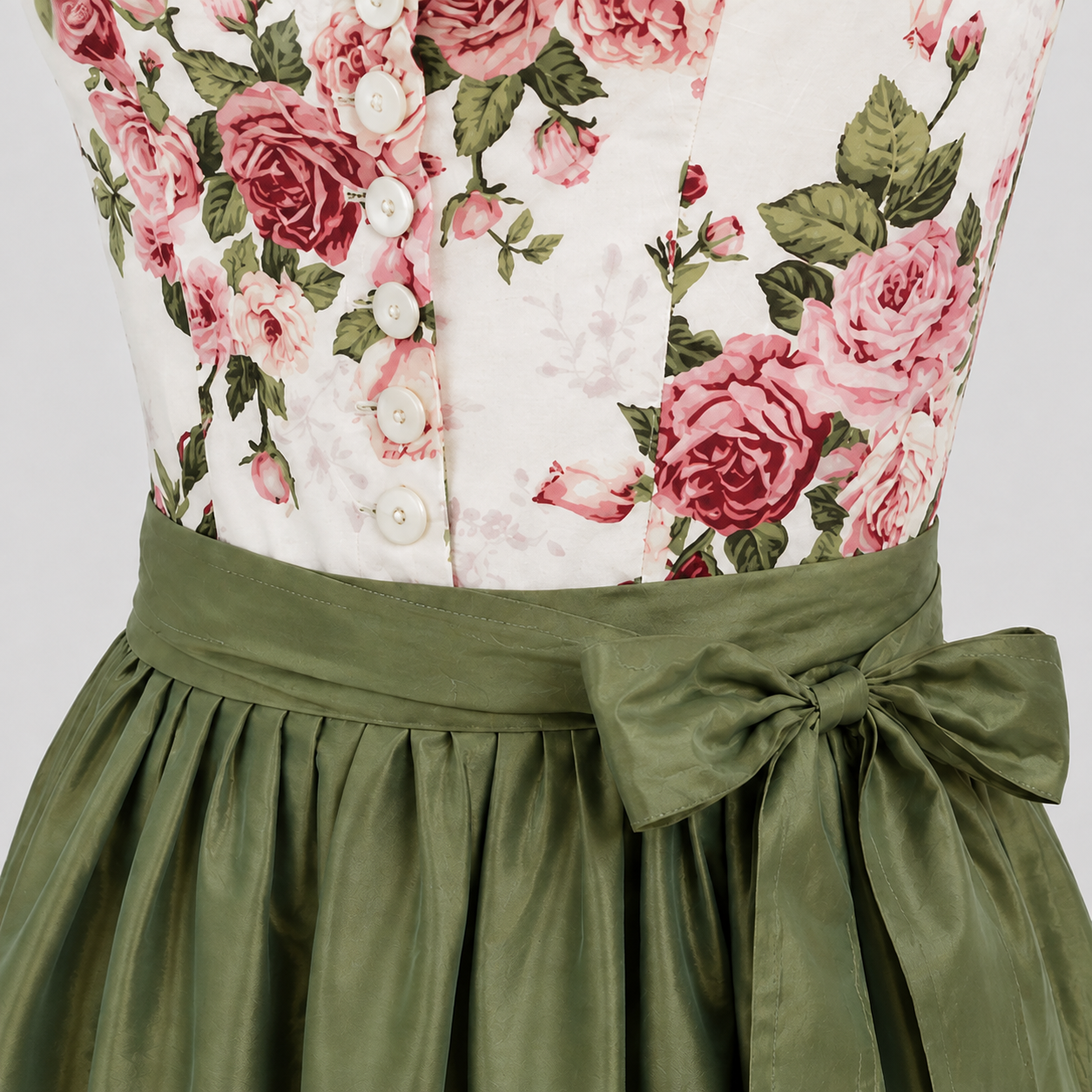 Close-up of Berwin & Wolff floral Dirndl bodice with white buttons and green apron bow