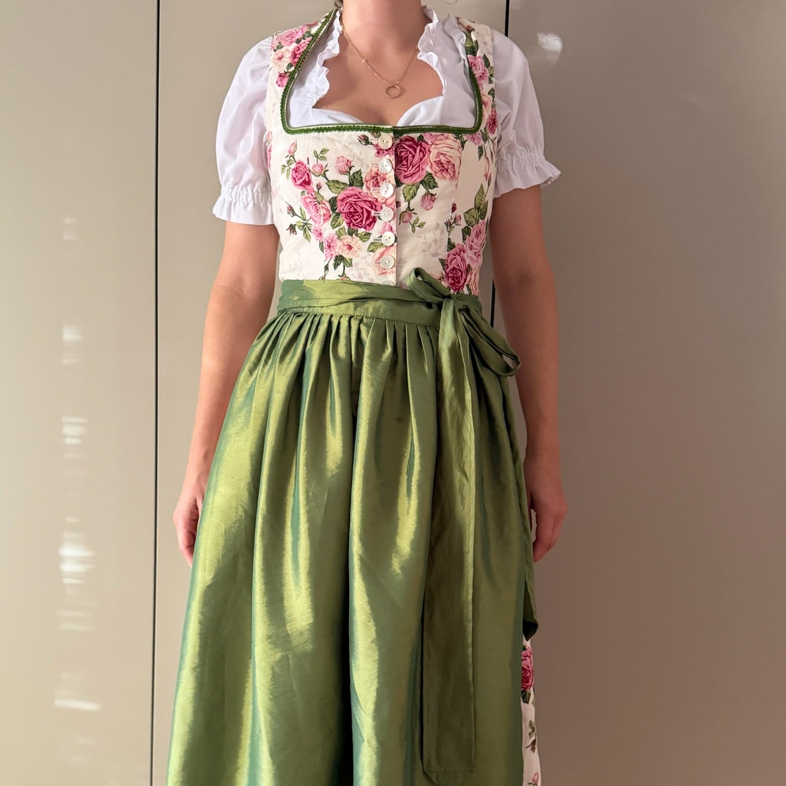 Berwin & Wolff ivory Dirndl with pink roses and green apron, worn with a white blouse