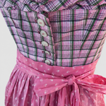 Close-up of Berwin & Wolff Dirndl with pink checked bodice, white buttons and bright pink apron bow