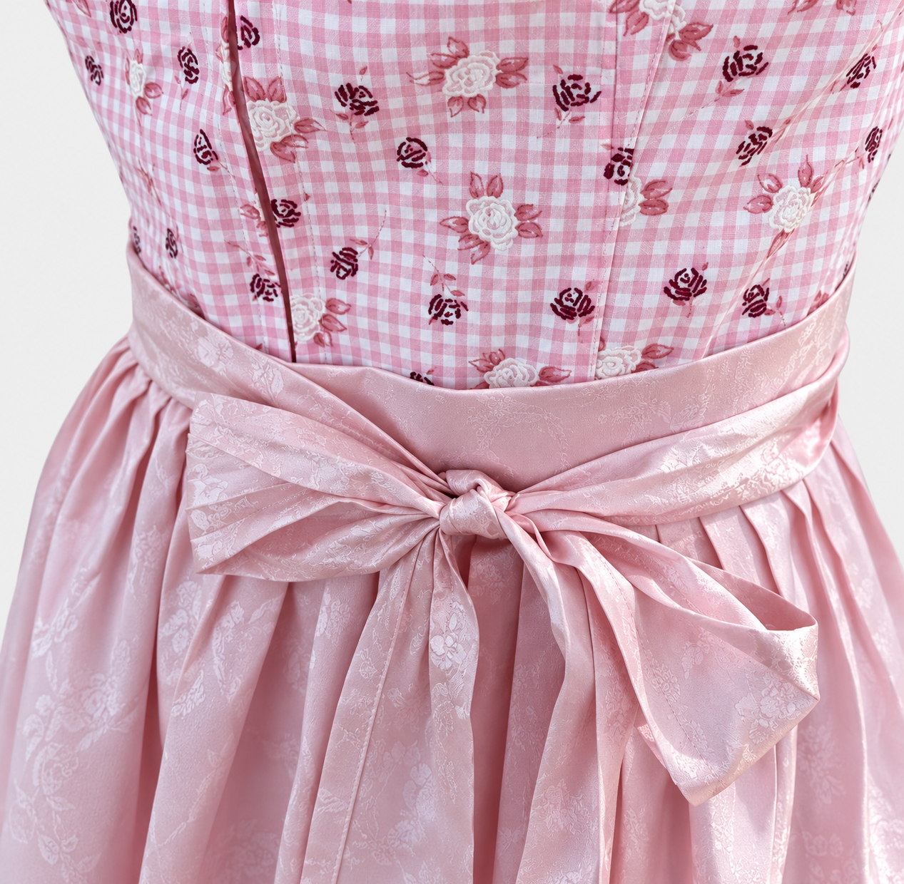 Detail of pink gingham Berwin & Wolff bodice with rose motifs and lustrous pink apron bow