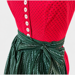 Detail of Berwin & Wolff red Dirndl bodice with white buttons and dark green patterned apron