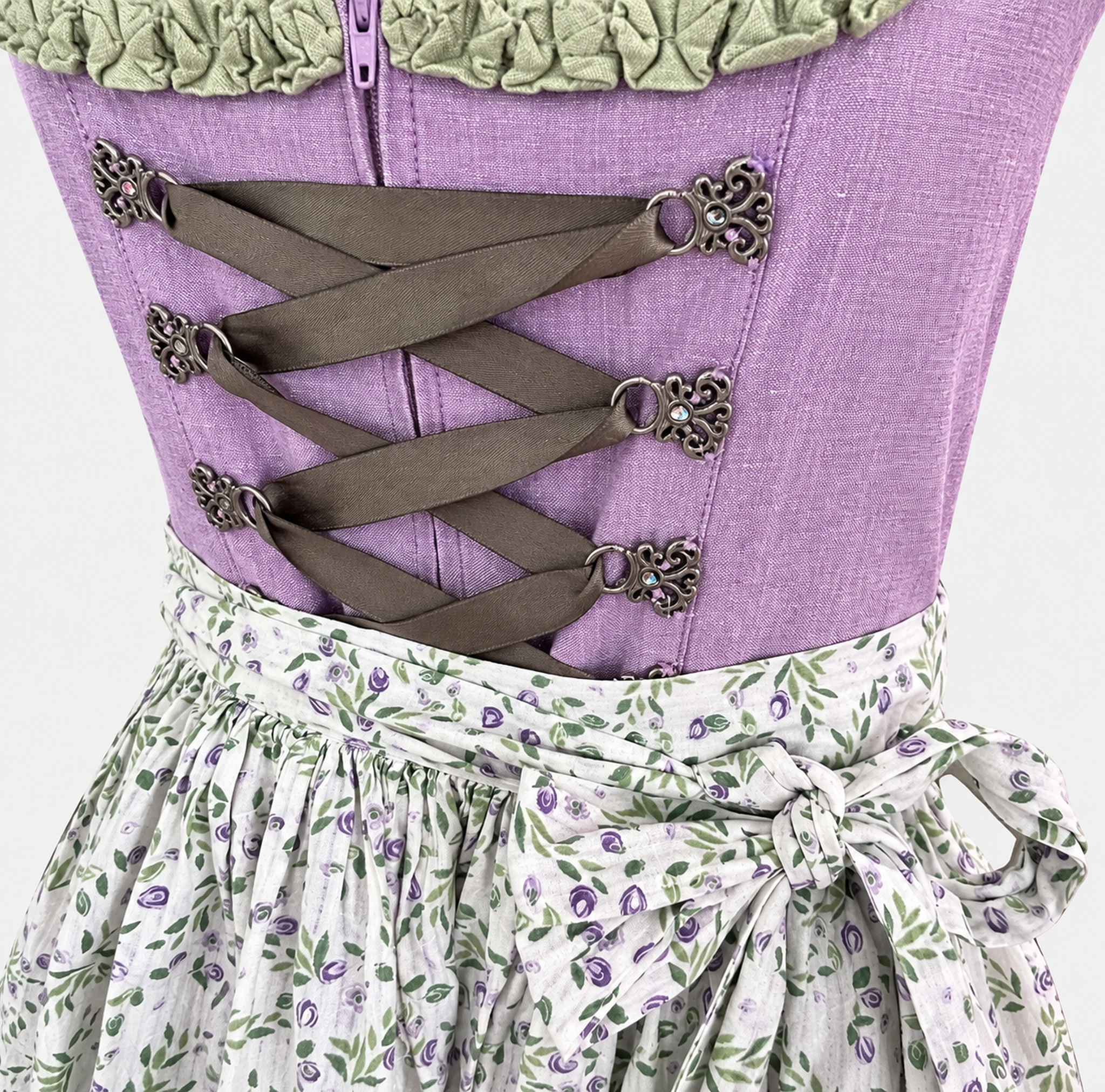 Detail of lavender Berwin & Wolff bodice with ribbon lacing, decorative metal hooks, front zip and sage green neckline trim