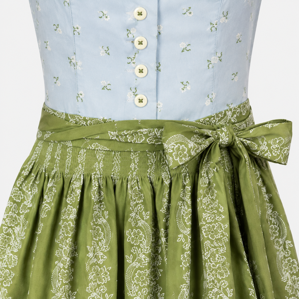 Detail of Hammerschmid Cutie Dirndl with light blue floral bodice, decorative buttons and green patterned apron bow