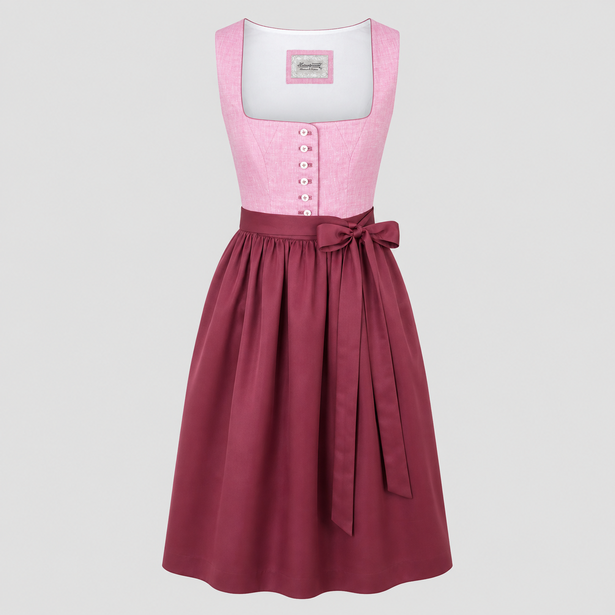 Pink and burgundy Heimatgwand Dirndl with button bodice and matching apron for Oktoberfest rental in Munich