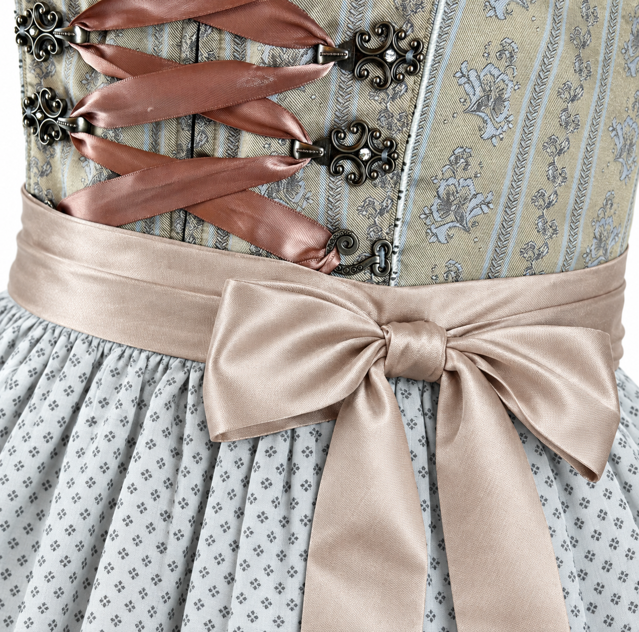 Detail of Krüger olive green Dirndl with ornamental bodice, taupe ribbon lacing, decorative hooks and bow over a patterned grey apron