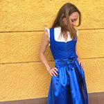 Handmade Ma.Le.Ma dirndl in royal blue—structured bodice, classic square neckline, silk skirt with wide bow apron and dotted underskirt; available for Oktoberfest rental in Munich.