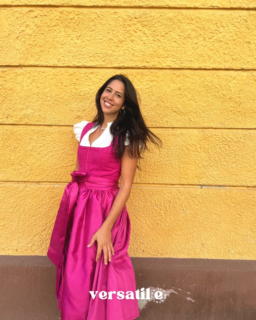 Ma.Le.Ma handmade fuchsia dirndl rental in Munich with structured bodice, square neckline, silk skirt and bow apron—Oktoberfest ready.