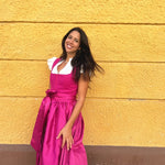 Ma.Le.Ma handmade fuchsia dirndl rental in Munich with structured bodice, square neckline, silk skirt and bow apron—Oktoberfest ready.
