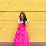 Ma.Le.Ma dirndl dress in vibrant pink, handmade in Munich—structured square neckline bodice, silk skirt, bow apron—for Oktoberfest dress hire.