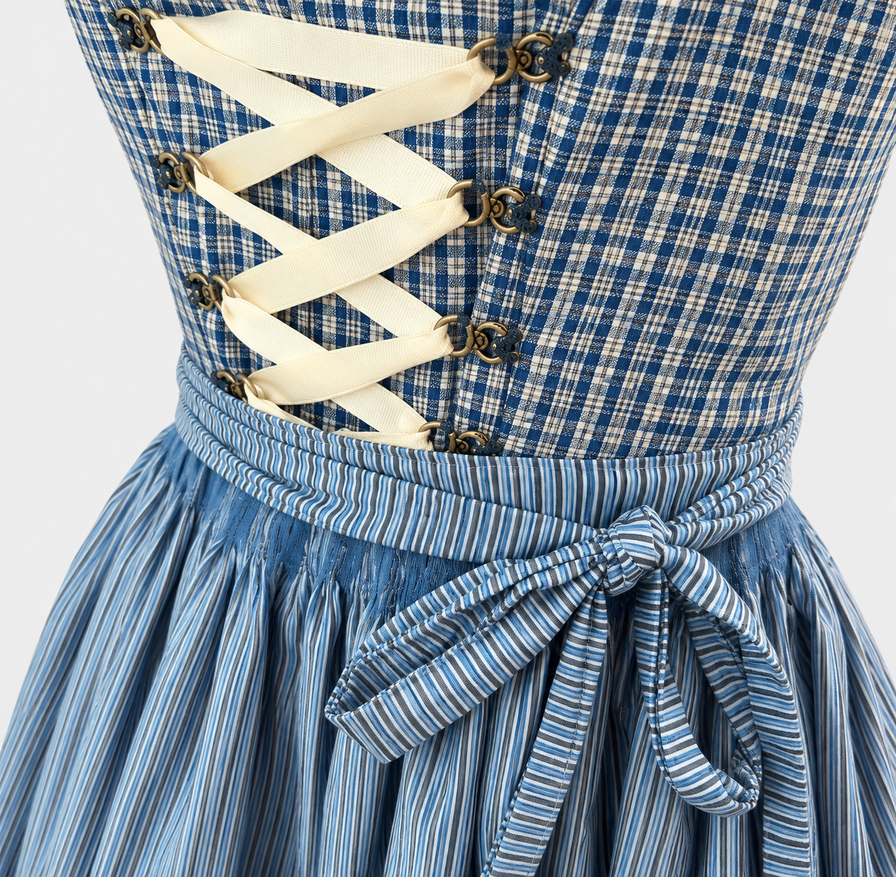 Detail of Redel blue checked bodice with cream ribbon lacing and striped apron bow