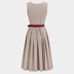 Back view of Wenger beige Dirndl with small white floral pattern and berry red waist sash