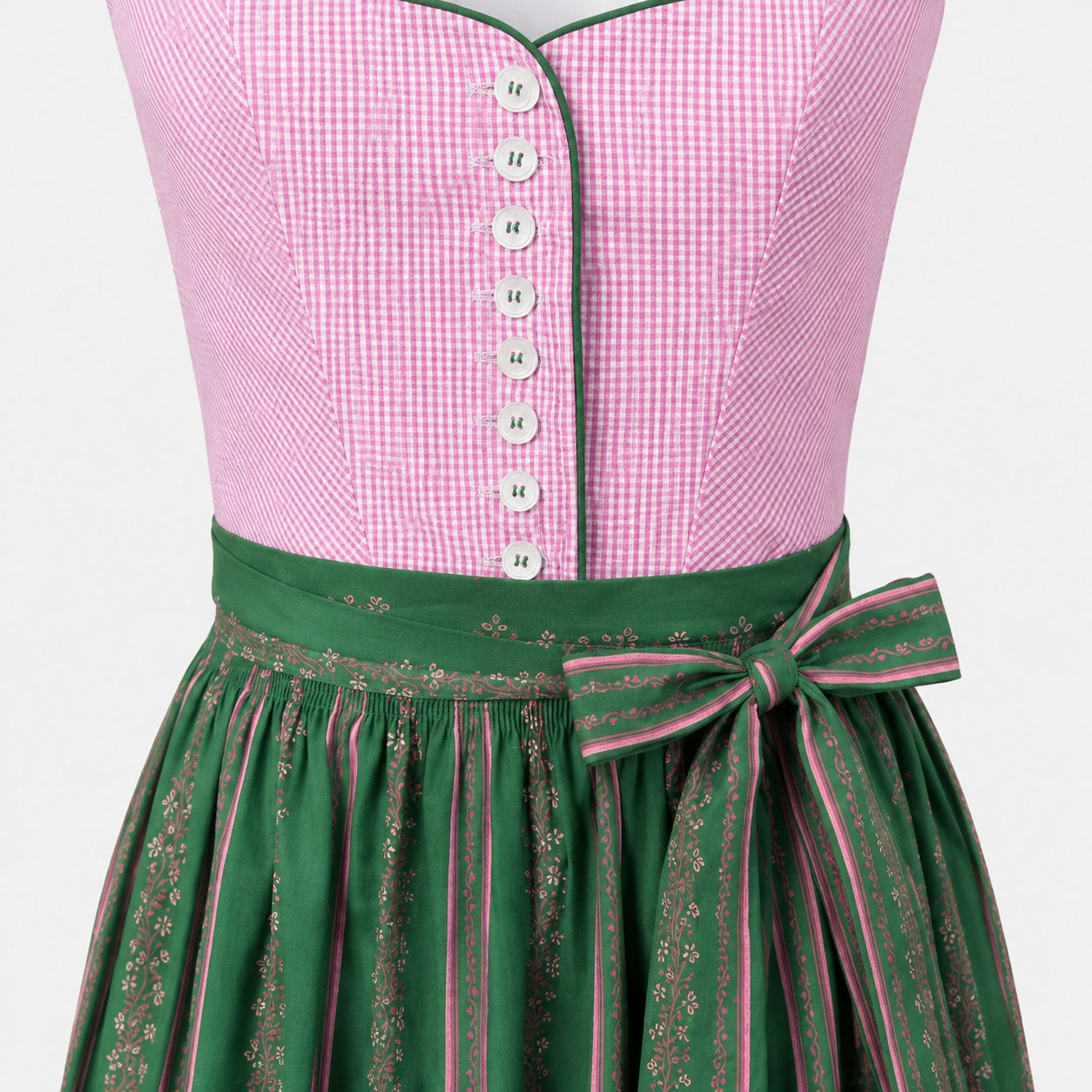 Detail of Wenger Dirndl with pink checked bodice, white buttons, green piping and patterned green apron bow